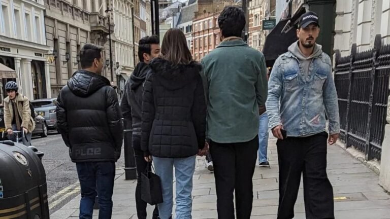 On the left Adrian ( Kriit Sanon's make up man can be seen walking next to her) mean while Kriti Sanon is holding hands of her rumored boyfriend in London